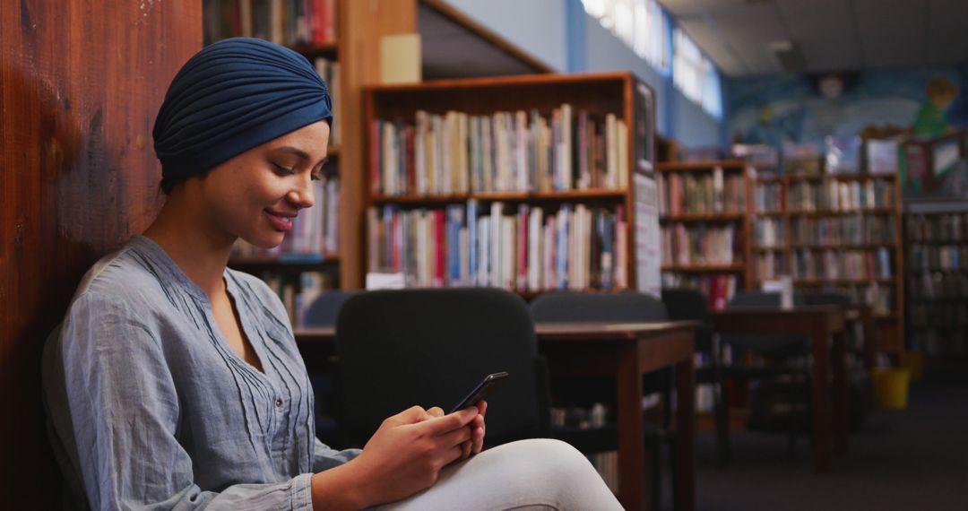 Young Woman with Turban Using Smartphone in Library - Free Images, Stock Photos and Pictures on Pikwizard.com