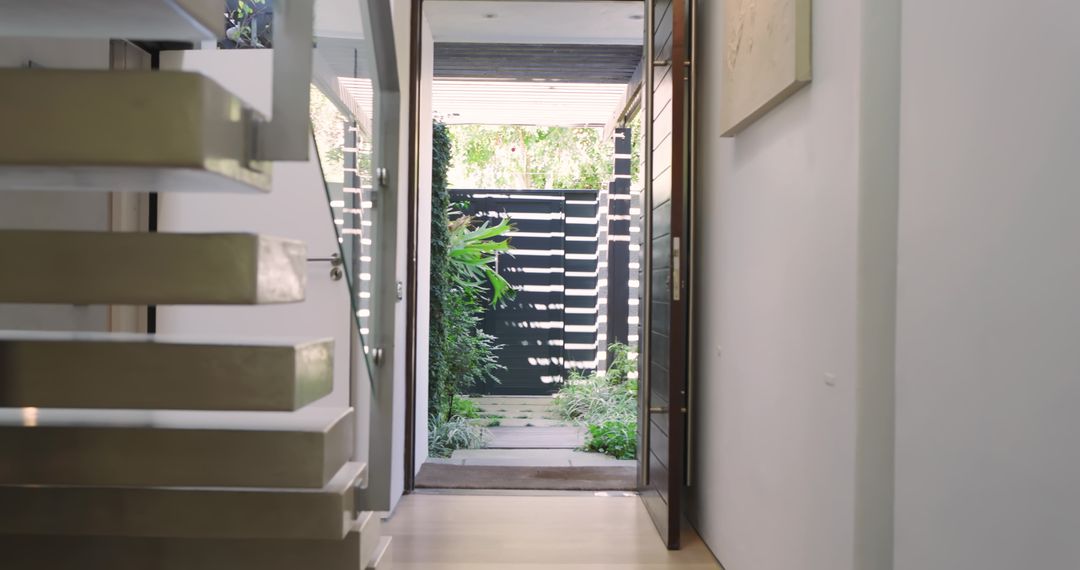 Modern Home Entryway with Floating Stairs and Courtyard View