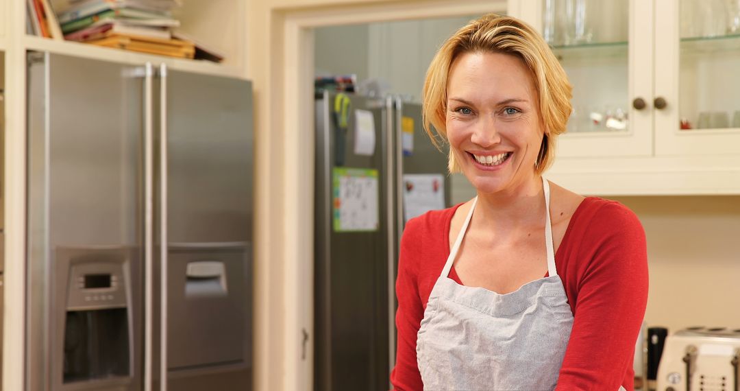 Smiling Woman in Kitchen with Apron - Free Images, Stock Photos and Pictures on Pikwizard.com