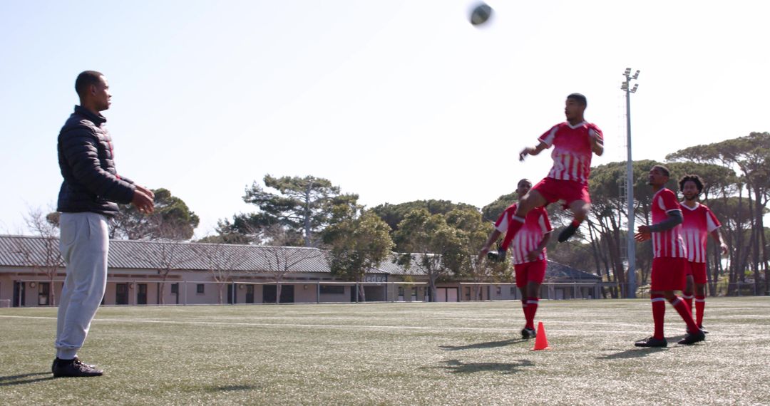 Youth Soccer Training Session with Coach on Sunny Field