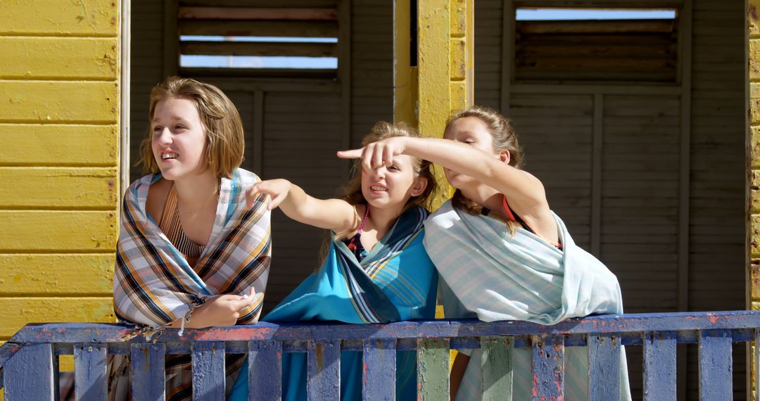 Three Teenage Girls Standing on Wooden Porch in Bright Sunlight - Free Images, Stock Photos and Pictures on Pikwizard.com