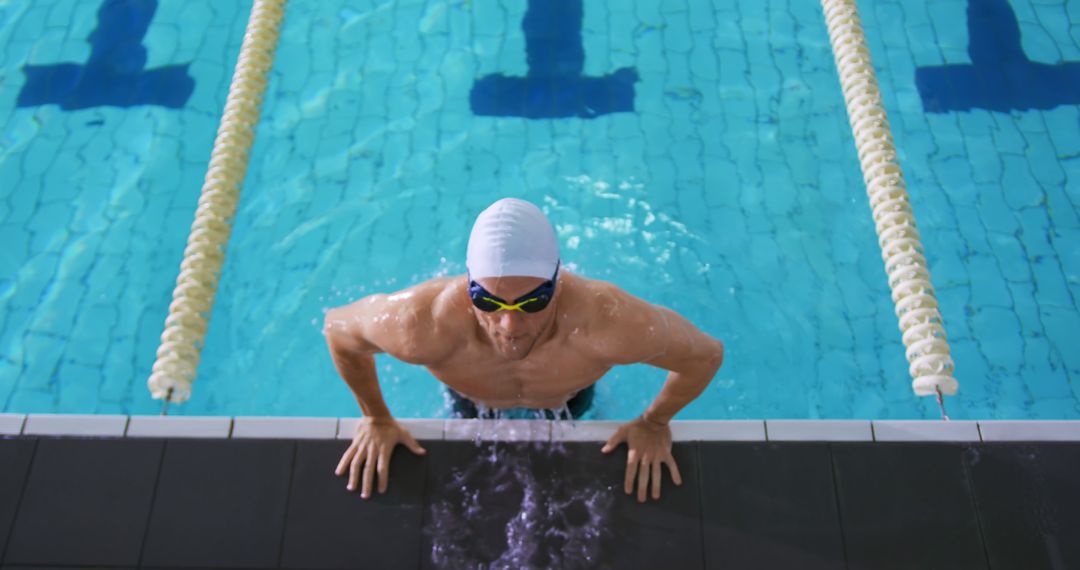 Professional Swimmer Emerging from Pool after Training Session - Free Images, Stock Photos and Pictures on Pikwizard.com