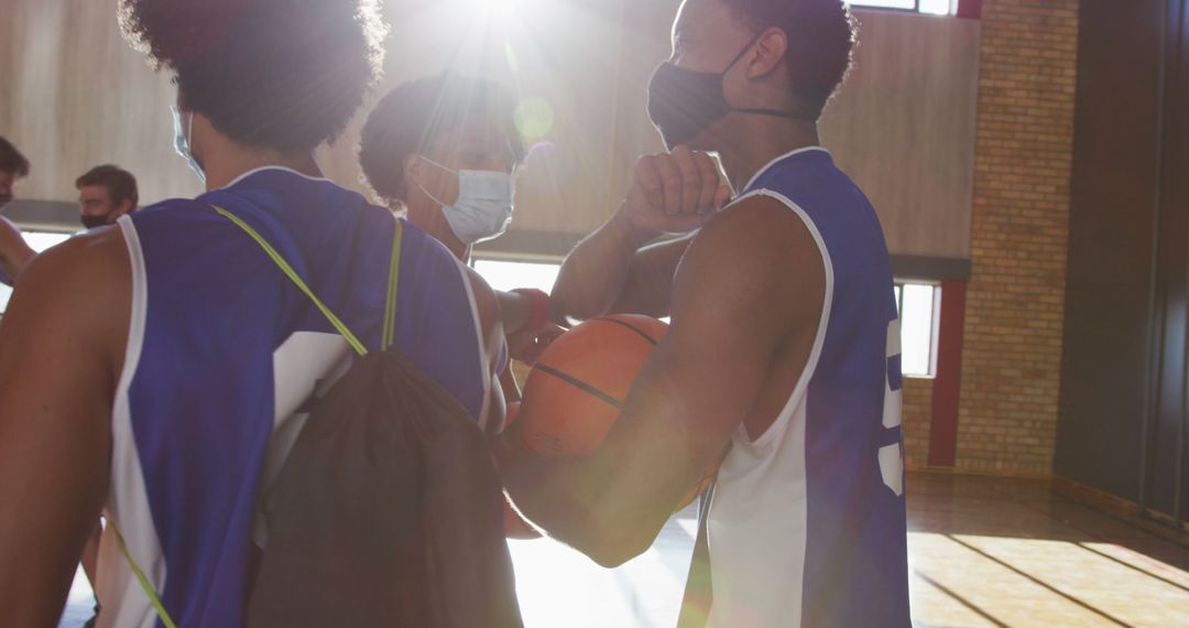 Diverse Basketball Team Greeting with Elbow Bumps and Masks