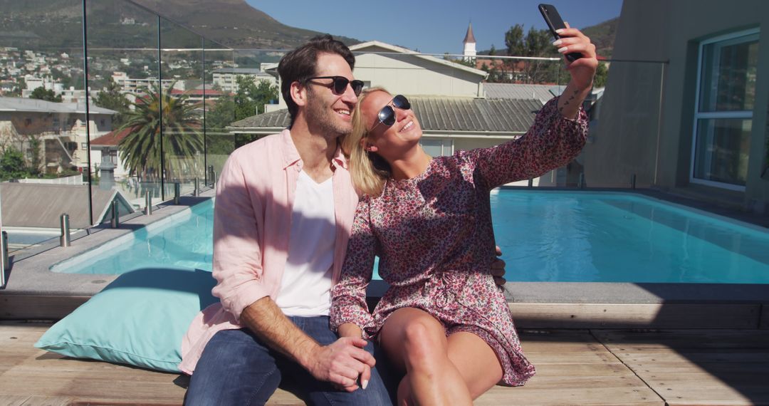 Happy Couple Taking Selfie by Rooftop Pool on Sunny Day - Free Images, Stock Photos and Pictures on Pikwizard.com