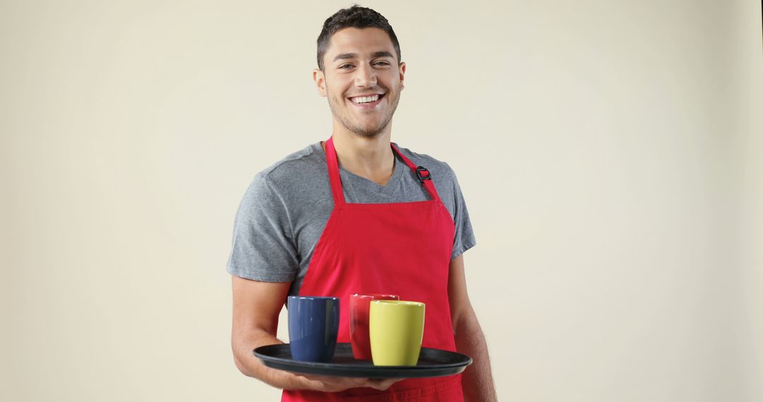 Smiling Male Barista Holding Tray with Coffee Mugs - Free Images, Stock Photos and Pictures on Pikwizard.com