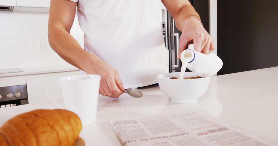 Close-up of Person Pouring Milk into Cereal Bowl in Modern Kitchen - Free Images, Stock Photos and Pictures on Pikwizard.com