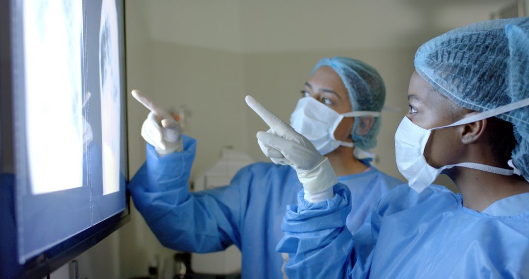 Surgeons Analyzing X-Ray Together in Operating Room