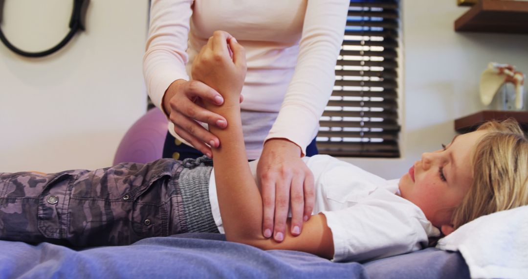 Physiotherapist Assisting Young Child in Clinic - Free Images, Stock Photos and Pictures on Pikwizard.com