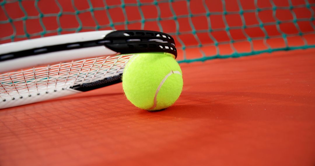 Tennis Racket and Ball on Red Court Close-Up - Free Images, Stock Photos and Pictures on Pikwizard.com