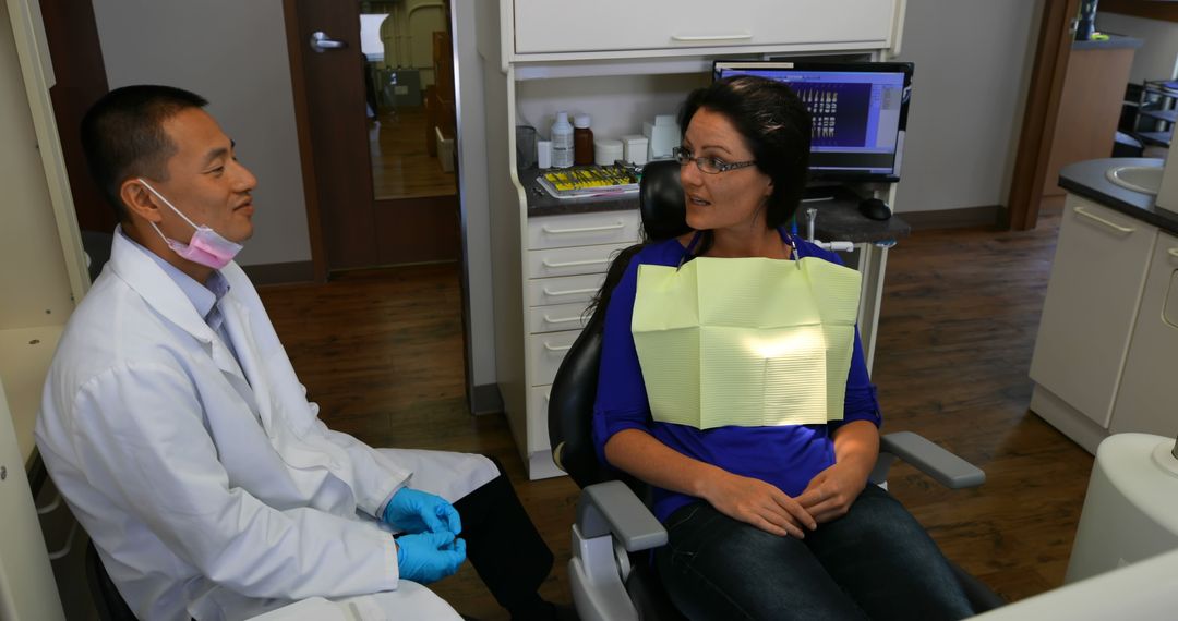 Dentist Discussing Treatment with Female Patient During Visit - Free Images, Stock Photos and Pictures on Pikwizard.com