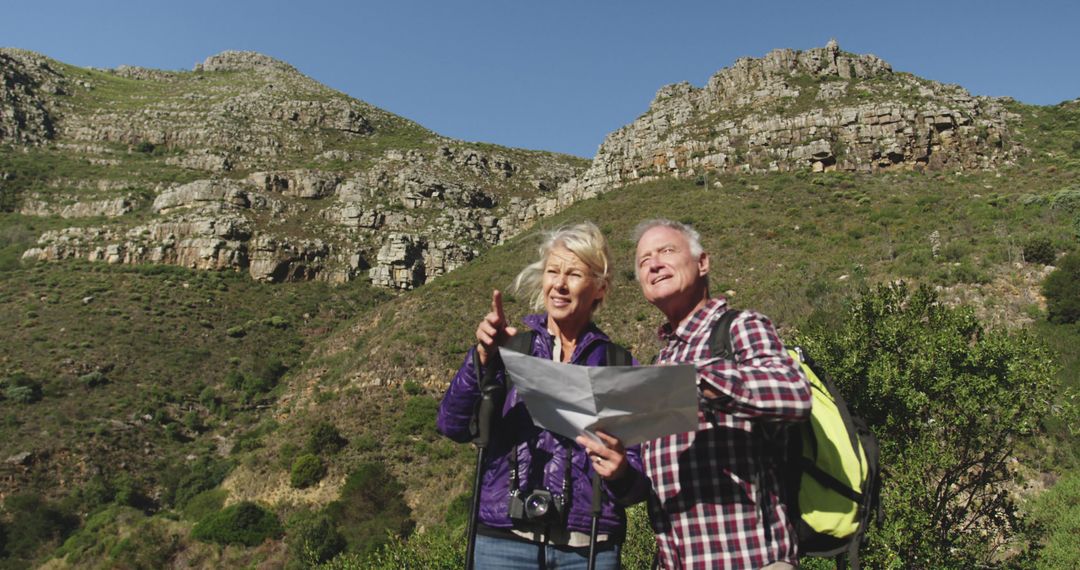 Senior couple exploring mountains with map - Free Images, Stock Photos and Pictures on Pikwizard.com