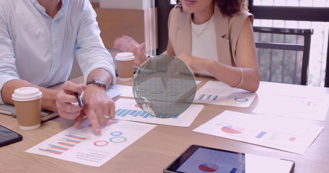 Colleagues Analyzing Business Reports at Meeting Table