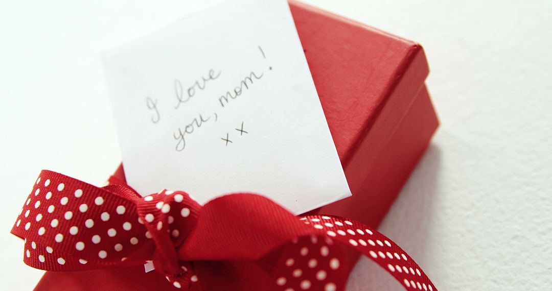 A red, polka-ribboned gift box for mom signifies love on special occasions or as thanks. - Free Images, Stock Photos and Pictures on Pikwizard.com