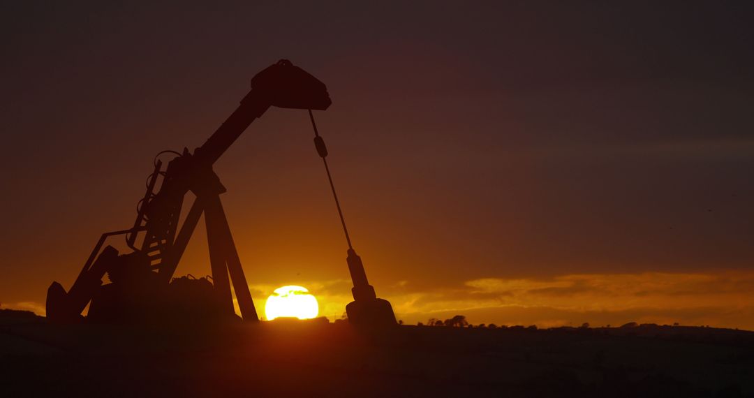 Dramatic Silhouette of Oil Pump Over Sunset - Free Images, Stock Photos and Pictures on Pikwizard.com