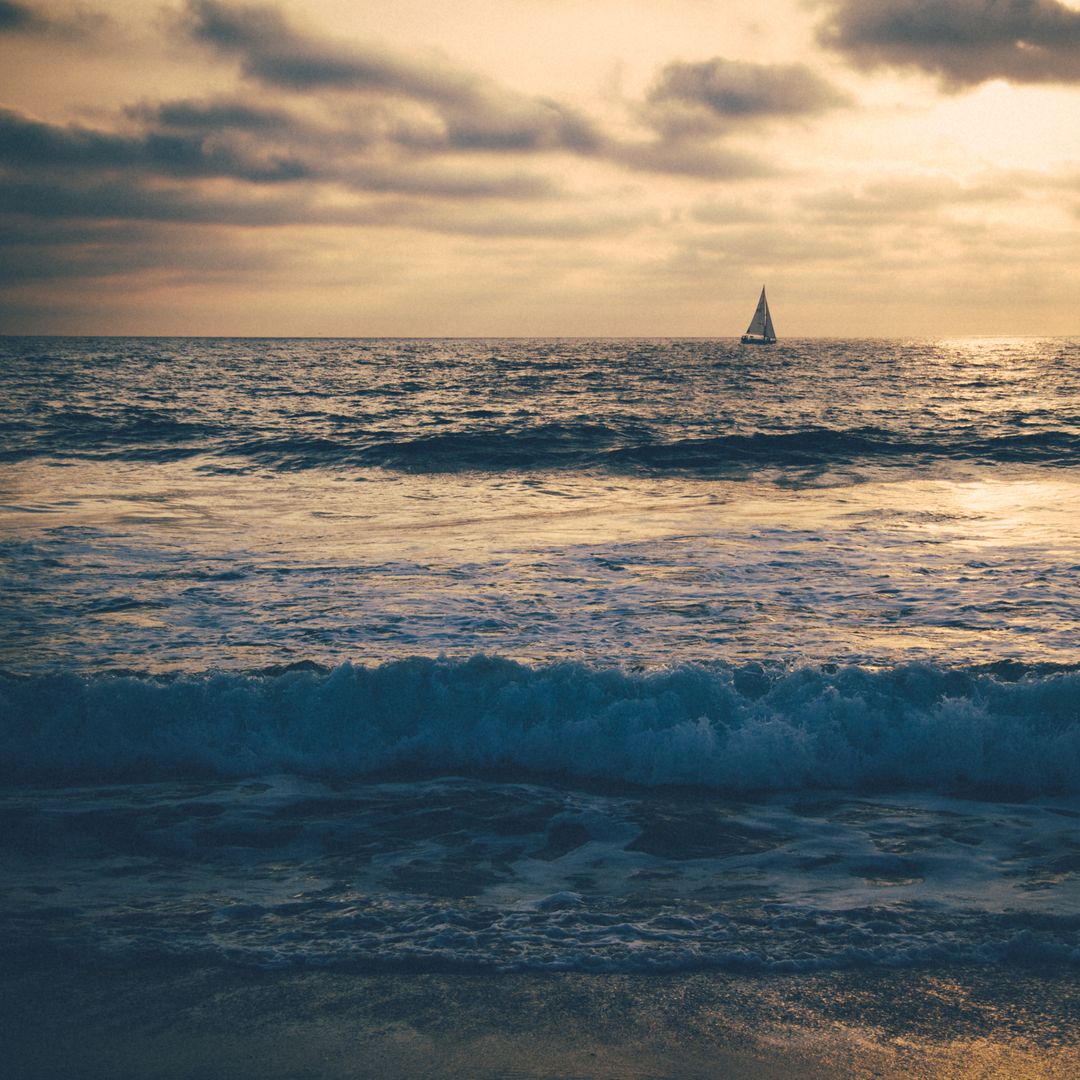 Solitary Sailboat on Tranquil Ocean at Sunset - Free Images, Stock Photos and Pictures on Pikwizard.com