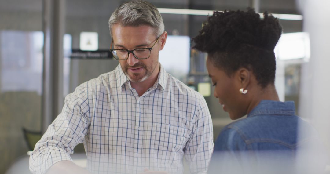 Businessman and Businesswoman Collaborating on Project