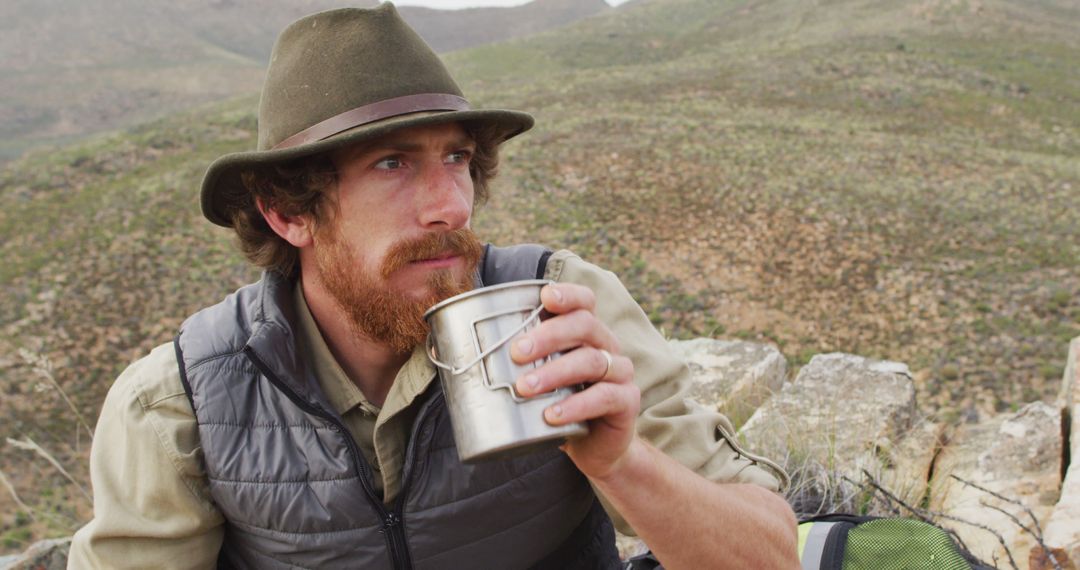 Bearded Man Drinking Water on Mountain Adventure