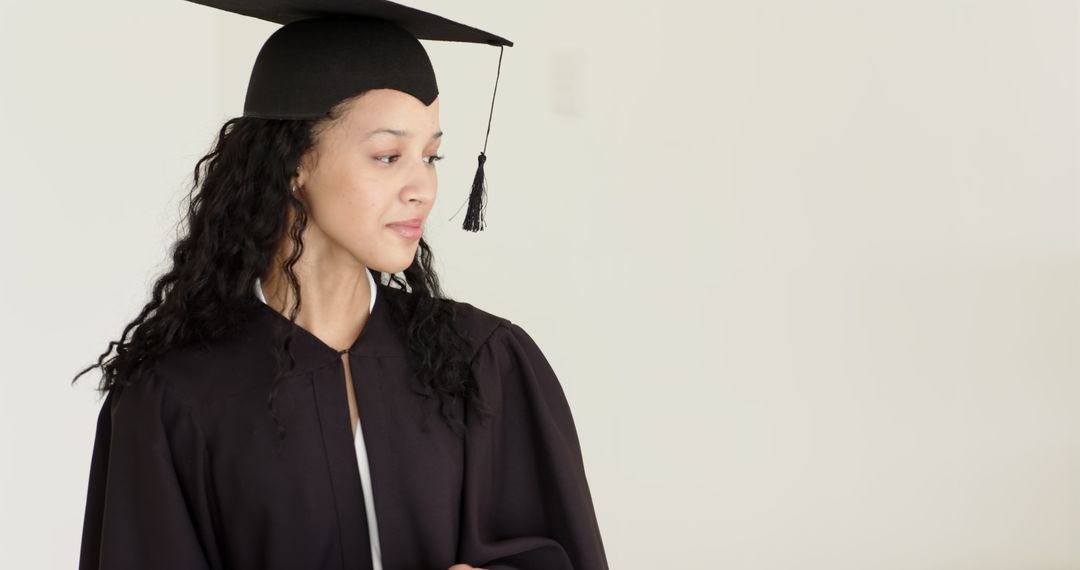 Graduate in Cap and Gown Using Tablet for Celebration