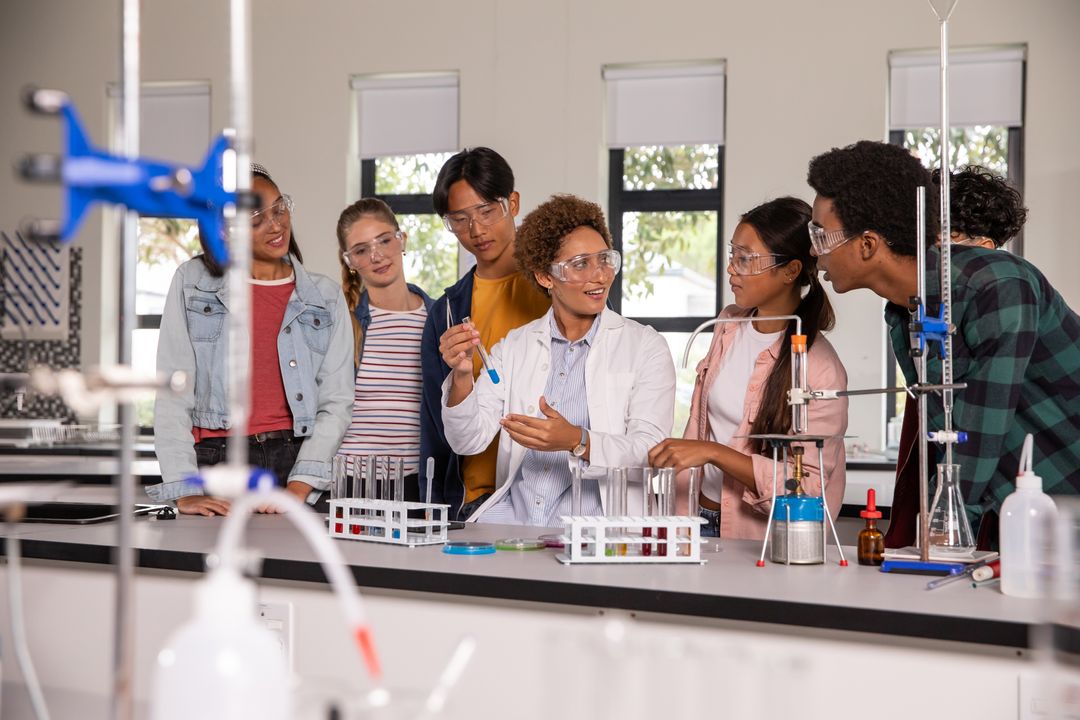 Diverse science instructor leading hands-on chemistry lab with engaged student group