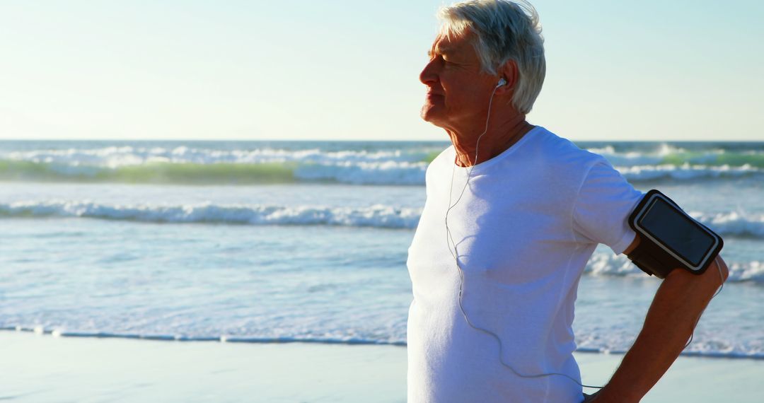 Senior Man Wearing Fitness Tracker Enjoying Beachside Jog - Free Images, Stock Photos and Pictures on Pikwizard.com