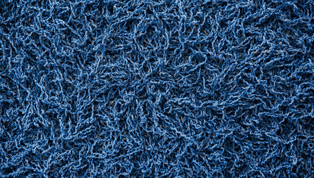 Macro Close-up Blue Shag Rug Showing Twisted Yarn and Dense Tufts, Textile Texture