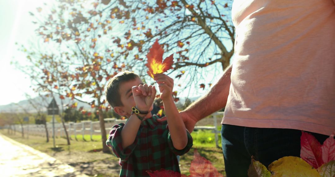 Boy Enjoying Autumn Outdoors with Man in Colorful Park