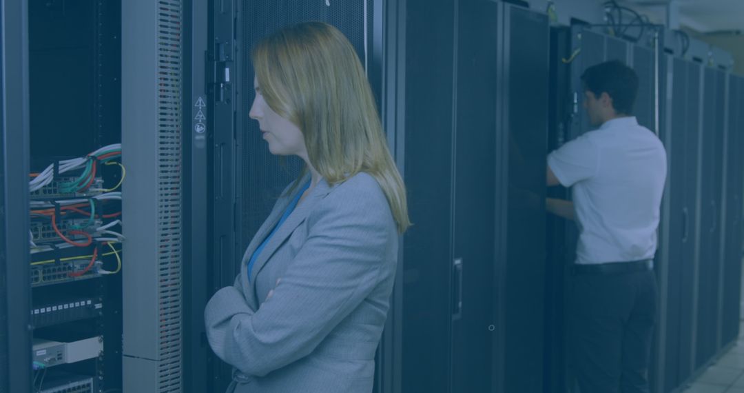 Technicians Inspecting Server Room Amidst Digital Overlay