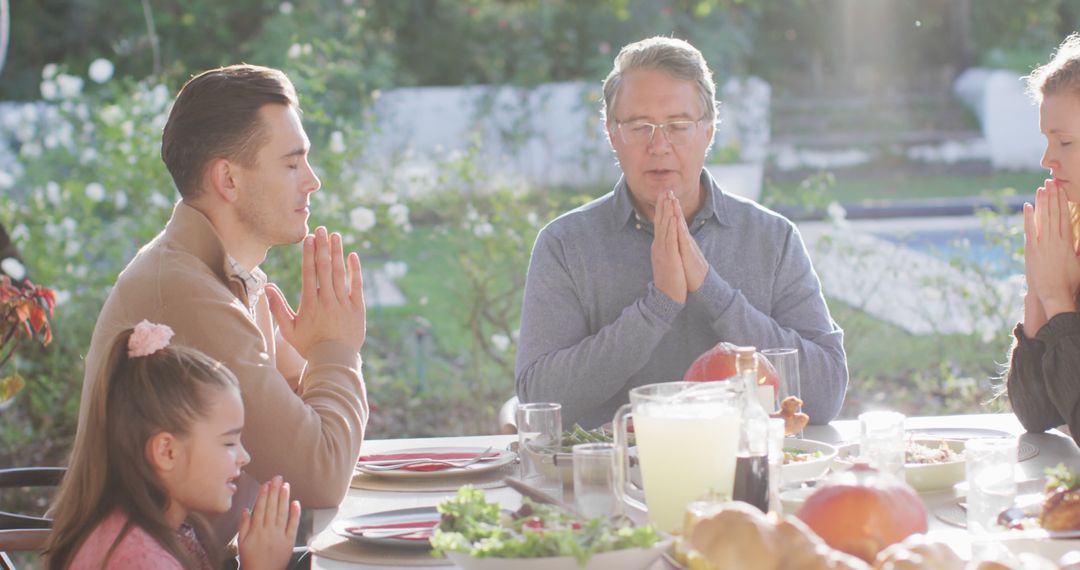 Family Praying at Outdoor Dining Table - Free Images, Stock Photos and Pictures on Pikwizard.com