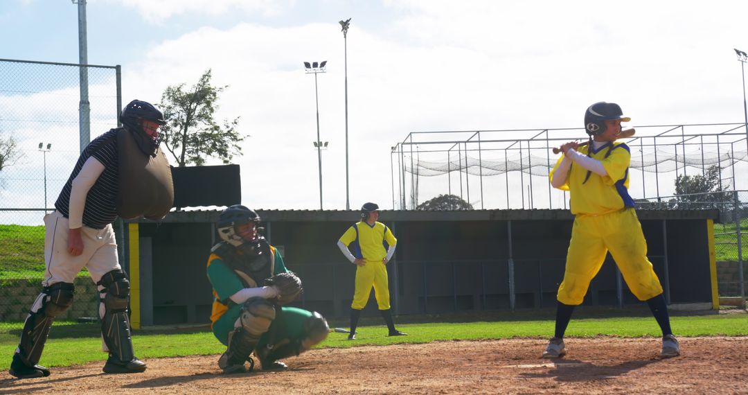 Diverse Softball Team in Action with Umpire and Catcher