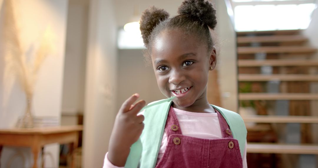 Cheerful Girl with Backpack Smiling Indoors