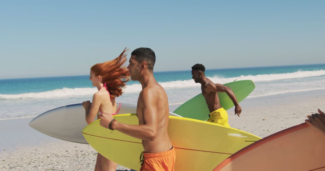 Young Adults Running with Surfboards on Sunny Beach - Free Images, Stock Photos and Pictures on Pikwizard.com