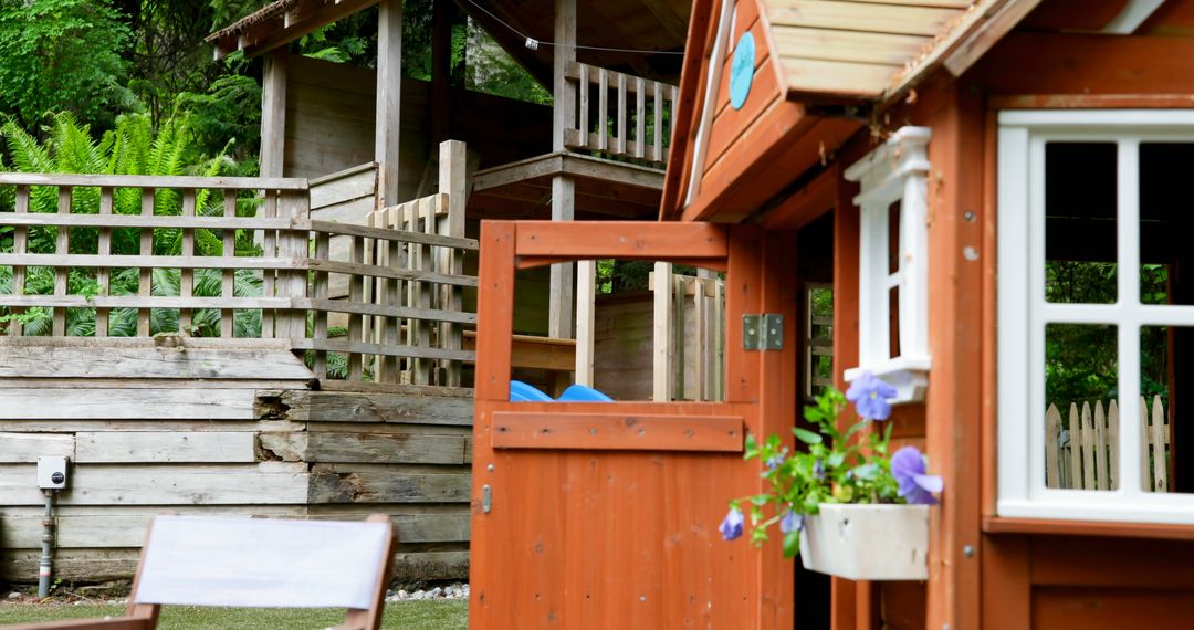 Backyard Wooden Playhouse and Fence with Greenery - Free Images, Stock Photos and Pictures on Pikwizard.com