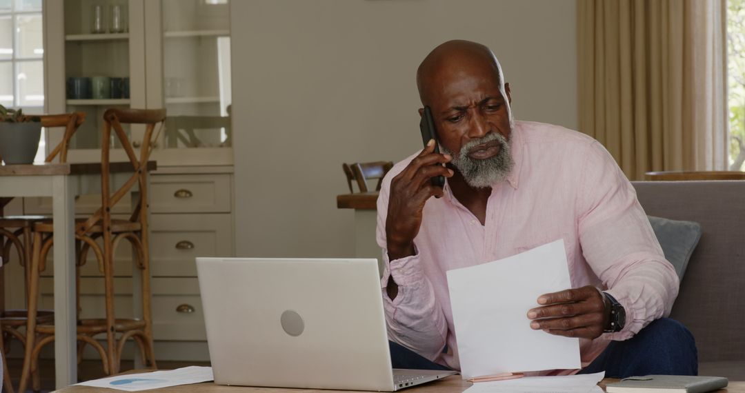Senior Man Consulting Remotely in Home Office with Laptop