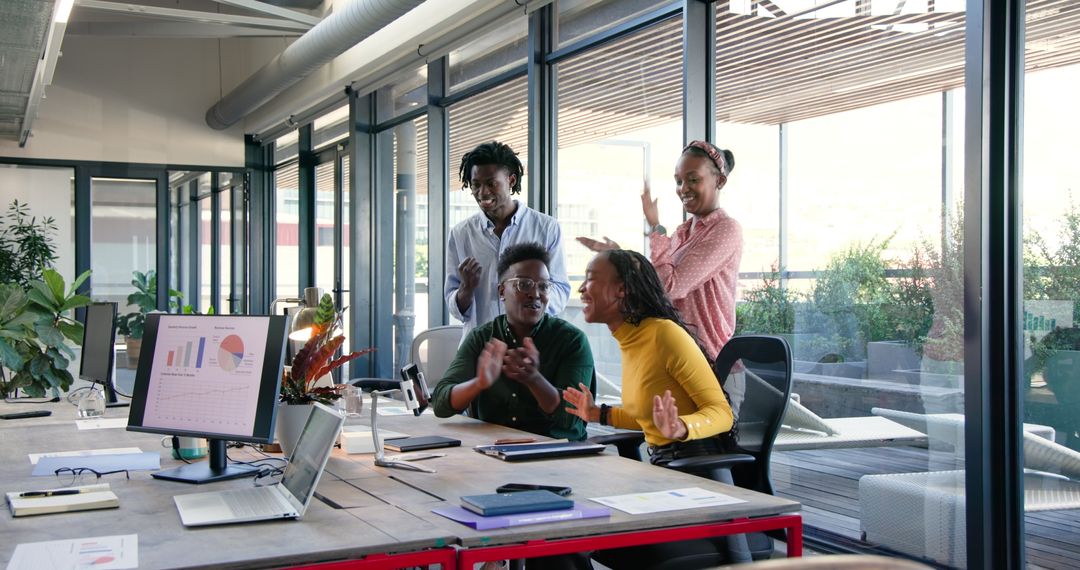 Diverse Team Enthusiastically Collaborating in Open Office