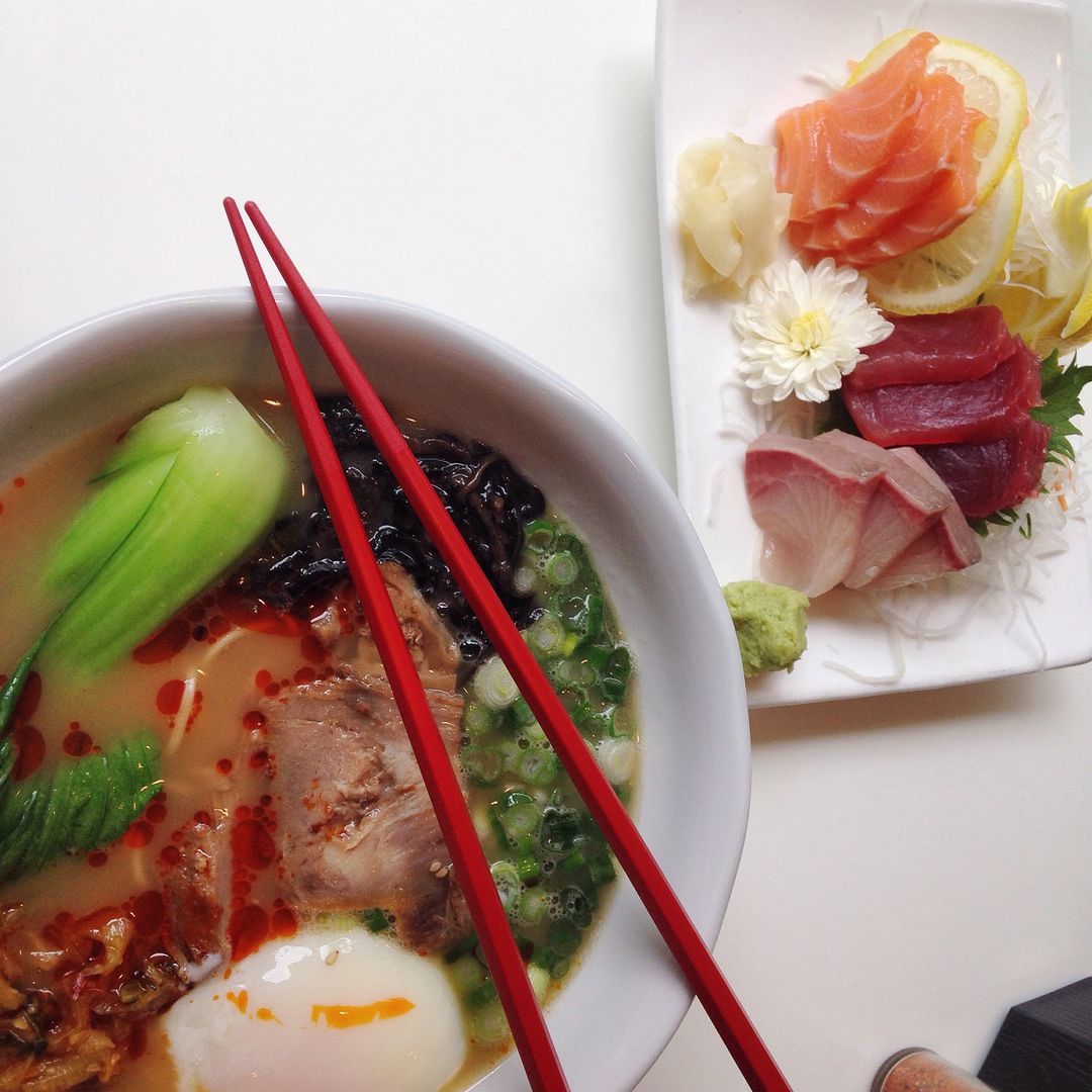 Overhead Ramen and Sashimi Pairing with Red Chopsticks Soft-Boiled Egg and Lemon Garnish