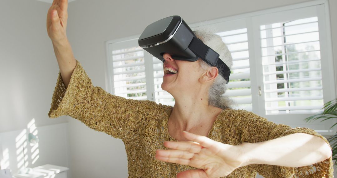 Elderly Woman Enjoying Virtual Reality at Home - Free Images, Stock Photos and Pictures on Pikwizard.com