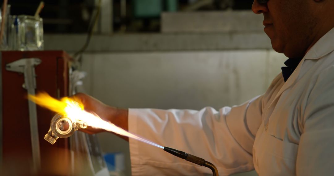 Male Scientist Heating Glass Tube with Blowtorch in Laboratory - Free Images, Stock Photos and Pictures on Pikwizard.com