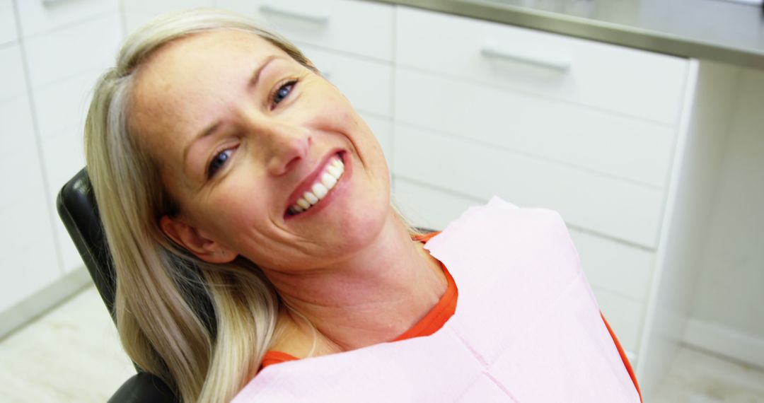 Smiling Woman in Dental Clinic Chair - Free Images, Stock Photos and Pictures on Pikwizard.com