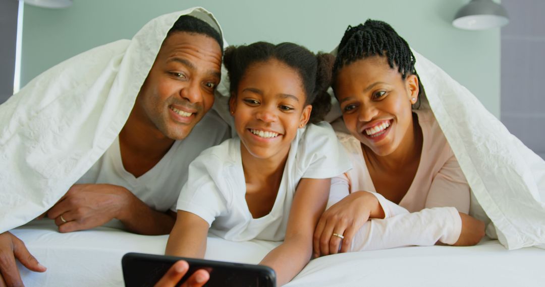 African American Family Taking a Selfie Together in Bed - Free Images, Stock Photos and Pictures on Pikwizard.com