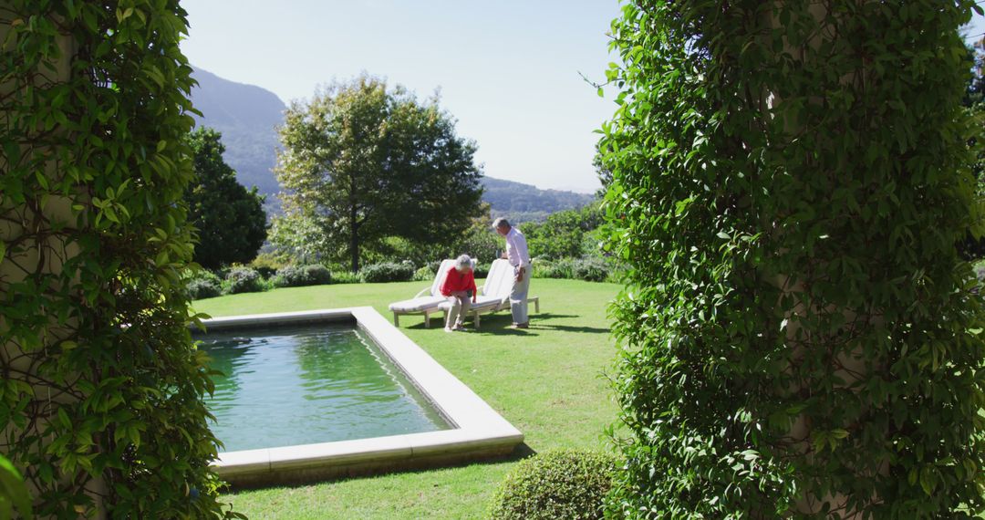 Senior Couple Relaxing by Pool in Scenic Backyard Garden - Free Images, Stock Photos and Pictures on Pikwizard.com