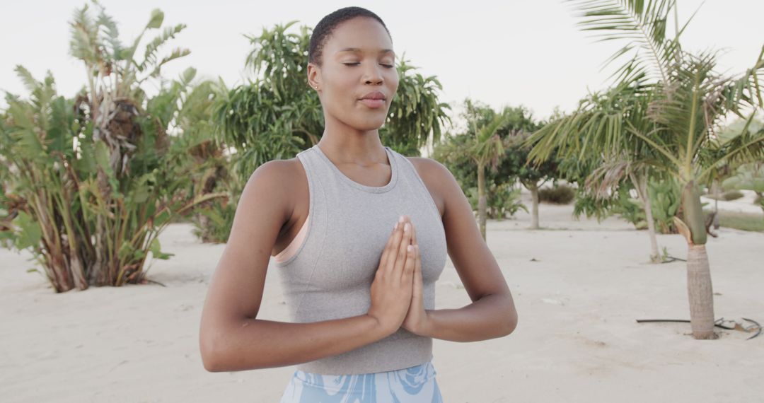 Peaceful Woman Meditating Outdoors in Tropical Beach Setting - Free Images, Stock Photos and Pictures on Pikwizard.com