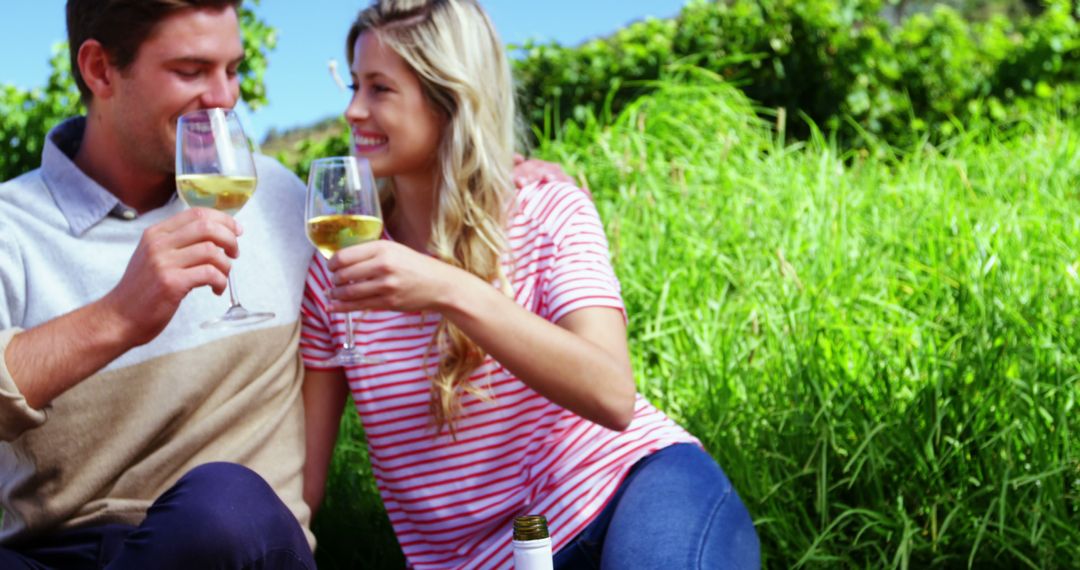 Couple Enjoying Wine Together in Lush Vineyard Scene
