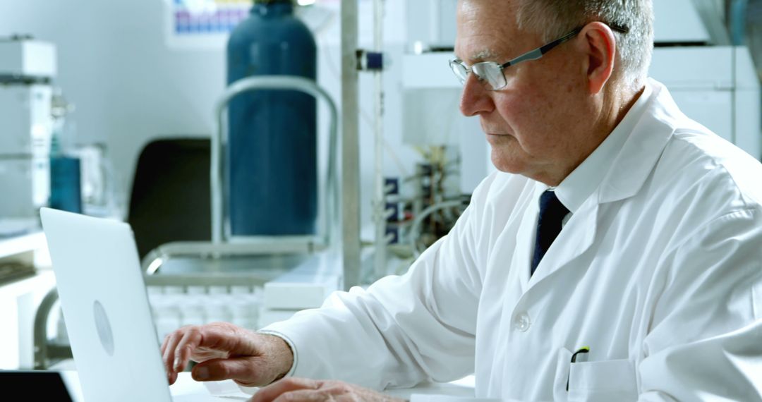 Senior Scientist Working on Laptop in Laboratory - Free Images, Stock Photos and Pictures on Pikwizard.com