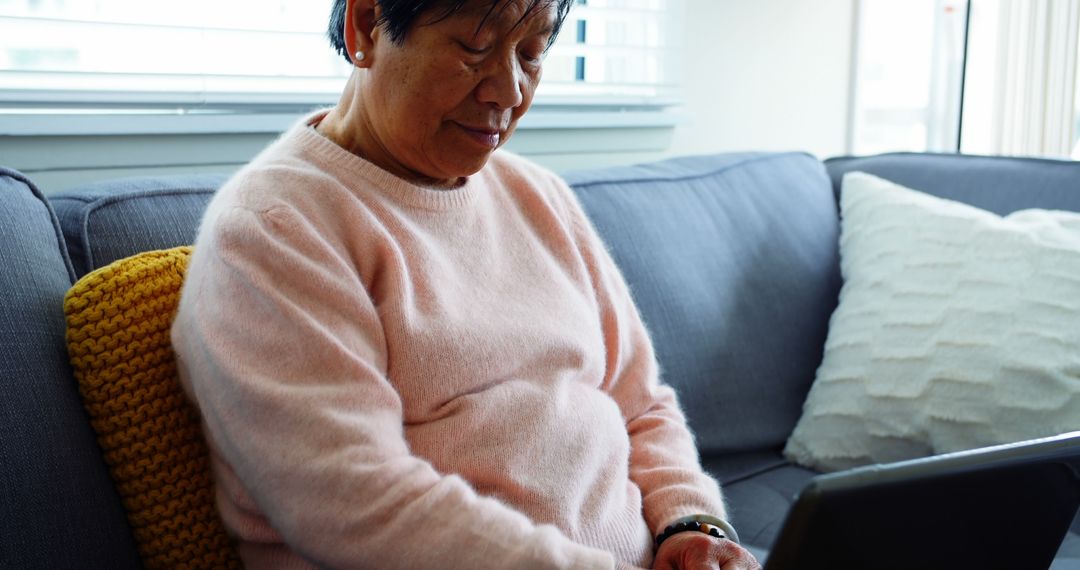 Elderly Woman Using Laptop on Sofa at Home - Free Images, Stock Photos and Pictures on Pikwizard.com