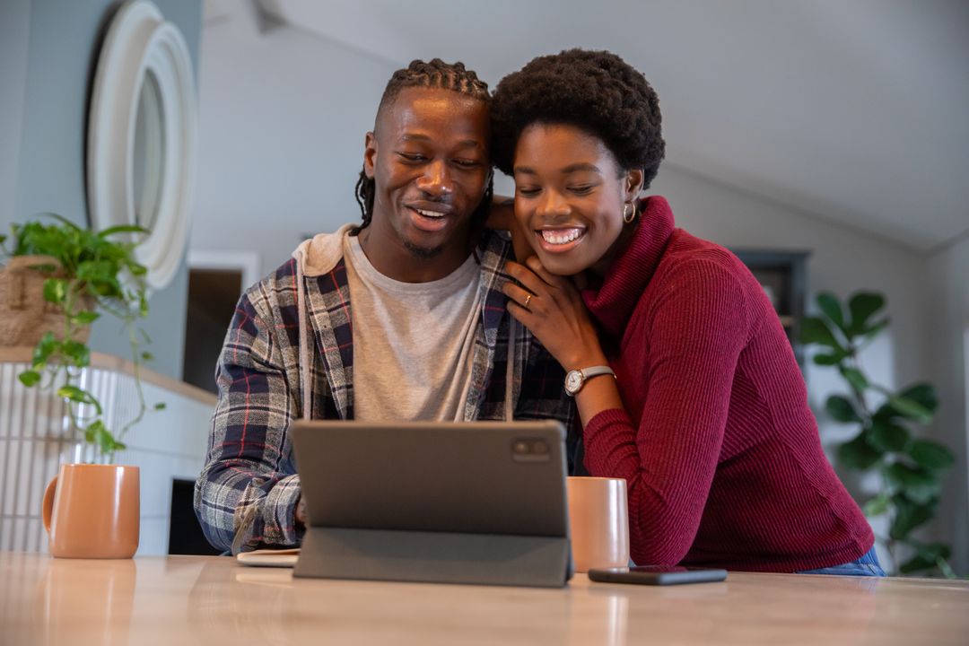 Happy Couple Relaxing at Home Viewing Tablet