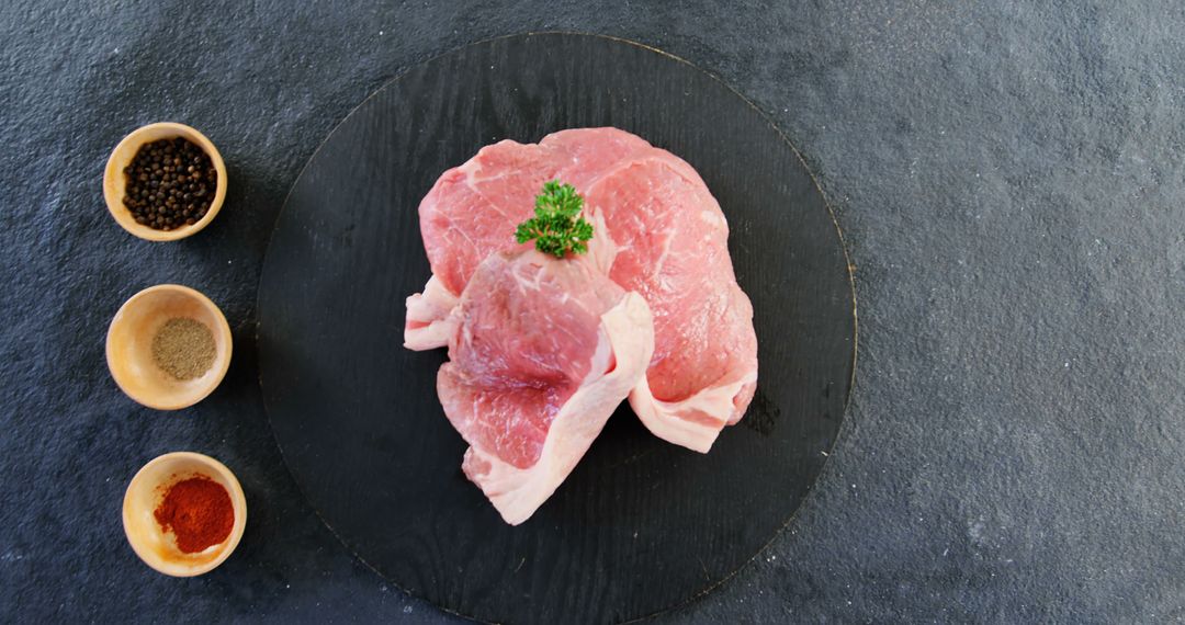 Raw Pork Steaks with Seasonings on Slate Background - Free Images, Stock Photos and Pictures on Pikwizard.com