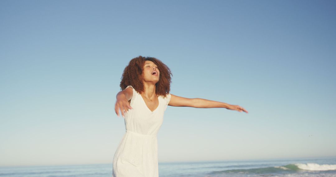 Joyful Young Woman Embracing Freedom at the Beach - Free Images, Stock Photos and Pictures on Pikwizard.com