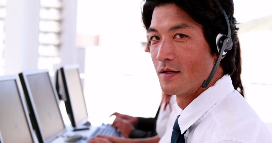 Friendly Call Center Agent with Headset Providing Customer Service