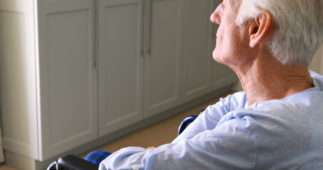 Elderly Man Sitting in Wheelchair at Home, Side View - Free Images, Stock Photos and Pictures on Pikwizard.com