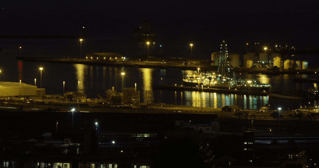 Illuminated harbor reflections at night with transparent sky